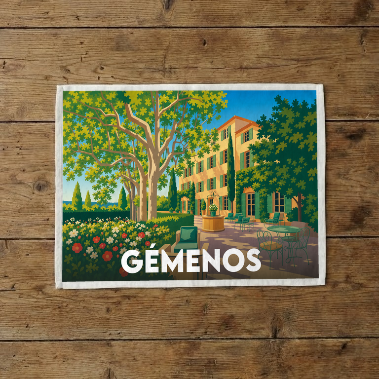 Torchon souvenir de la ville de Gémenos avec une illustration stylisée d'une bastide provençale.