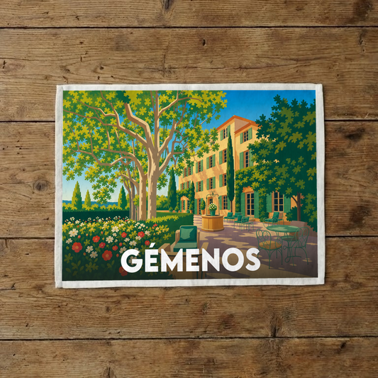 Torchon souvenir de la ville de Gémenos avec une illustration stylisée d'une bastide provençale.