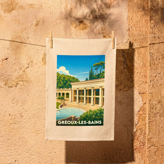 Torchon souvenir de la ville de Gréoux-les-Bains orné d'une illustration stylisée de ses thermes.