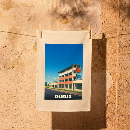 Torchon souvenir de la ville de Gueux avec une illustration stylisée de ses célèbres tribunes de circuit.