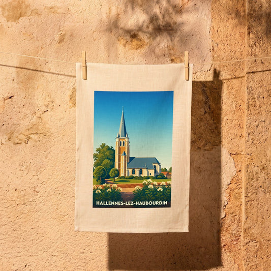 Torchon souvenir de Hallennes-lez-Haubourdin illustré par une église stylisée sous un ciel bleu.