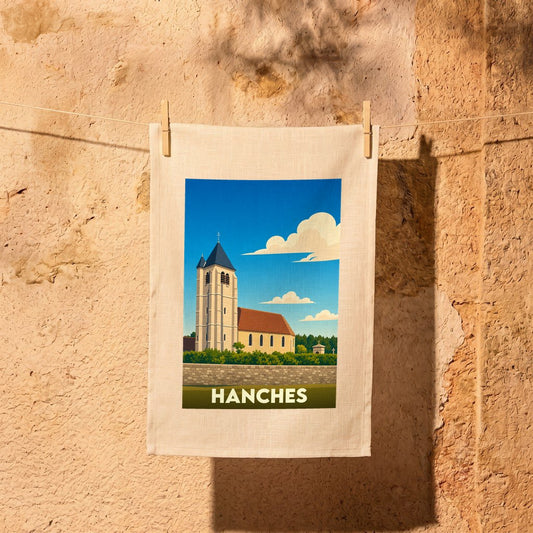 Torchon souvenir de la ville de Hanches avec une illustration stylisée de son église sous un ciel bleu.