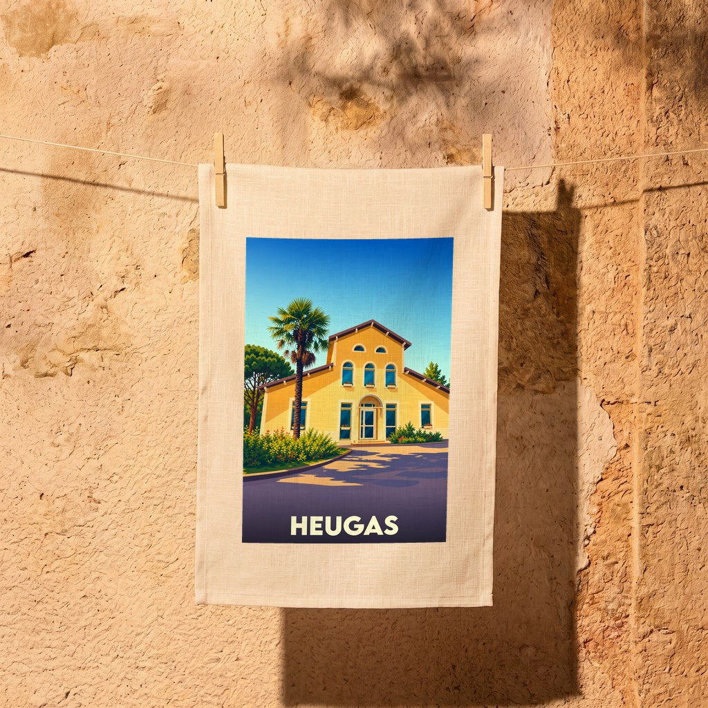 Torchon souvenir de la ville de Heugas avec une illustration stylisée d'une maison landaise sous un palmier.