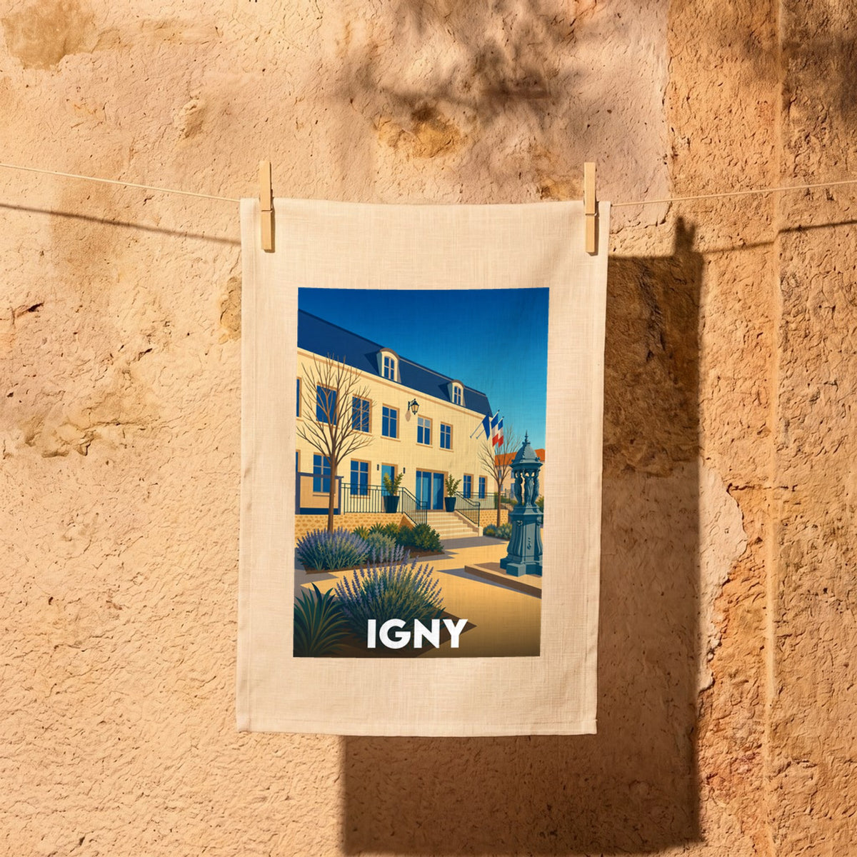 Torchon souvenir de la ville d'Igny illustrant l'hôtel de ville et sa fontaine dans un style graphique épuré.