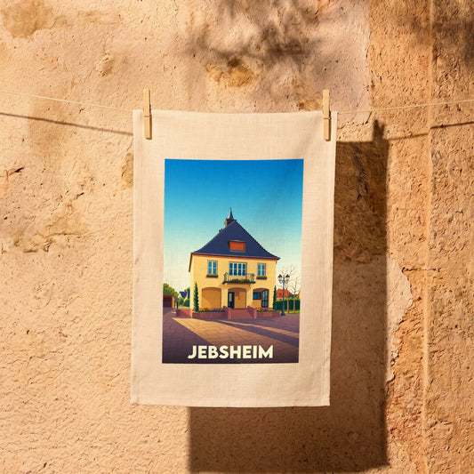 Torchon souvenir de la ville de Jebsheim illustré par un dessin stylisé d'une maison traditionnelle.