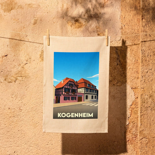 Torchon souvenir de la ville de Kogenheim illustré d'un dessin stylisé de maisons à colombages.