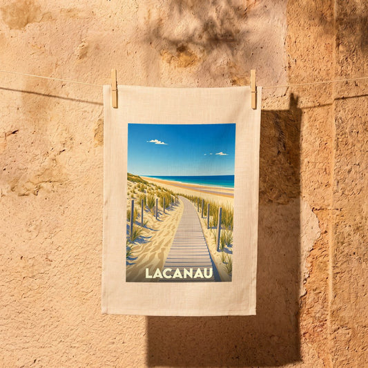 Torchon souvenir de la ville de Lacanau avec une illustration stylisée d'un chemin de plage.
