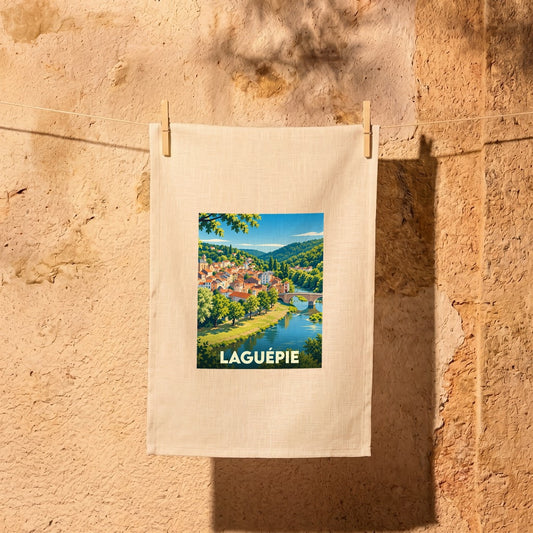 Torchon souvenir de la ville de Laguépie avec une illustration stylisée.