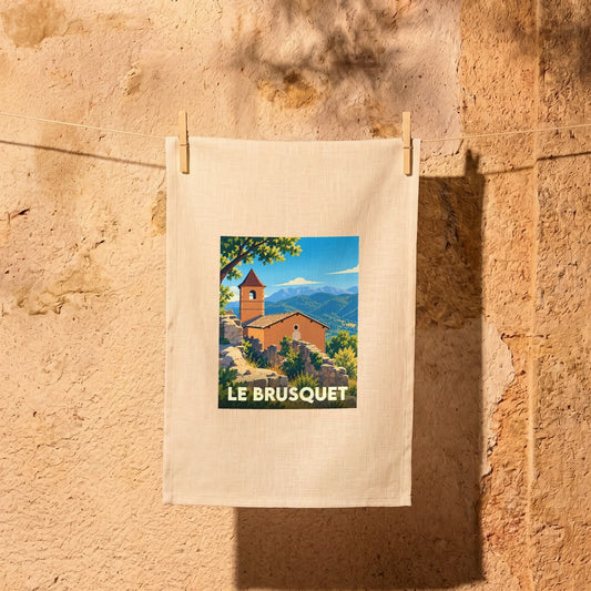 Torchon souvenir de la ville de Le Brusquet avec une illustration stylisée d'un paysage provençal.