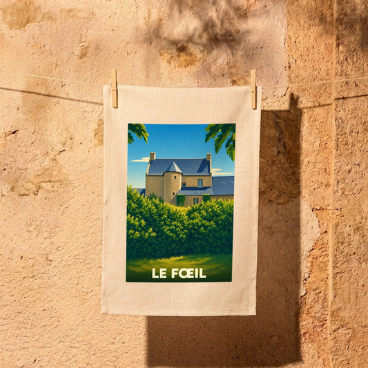 Torchon souvenir de la commune de Le Fœil avec une illustration stylisée d'un manoir breton.