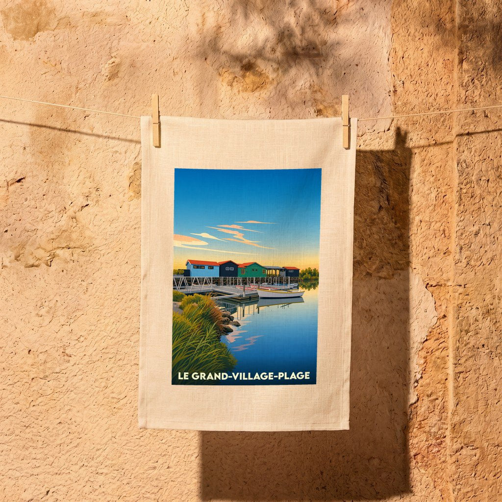 Torchon souvenir de Le Grand-Village-Plage illustrant des cabanes colorées au bord de l'eau.