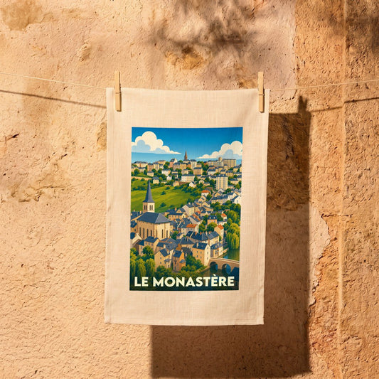 Torchon souvenir de la ville de Le Monastère avec une illustration stylisée.