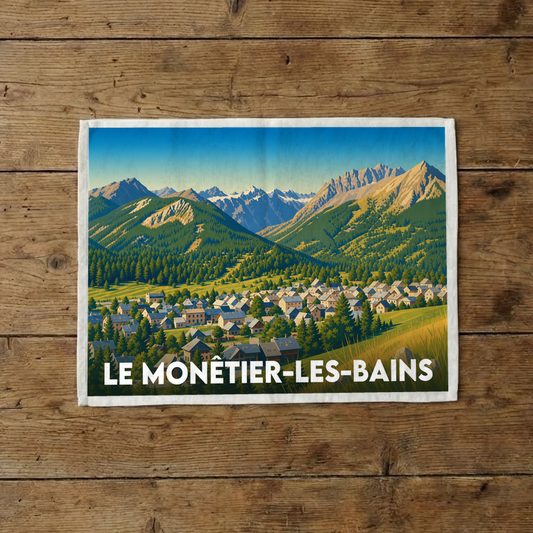 Torchon souvenir de la ville de Le Monêtier-les-Bains avec une illustration stylisée de paysages montagneux.