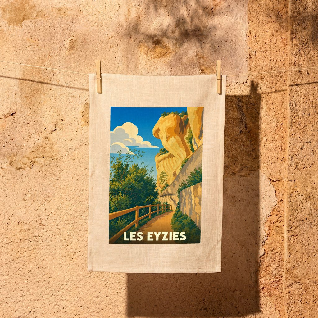 Torchon souvenir de la ville de Les Eyzies avec une illustration stylisée de ses falaises.