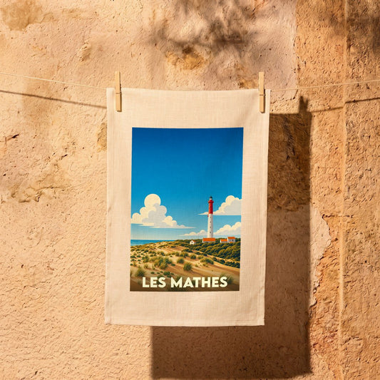 Torchon souvenir de la ville de Les Mathes avec une illustration stylisée d'un phare et de dunes.