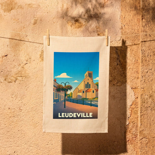 Torchon souvenir de la ville de Leudeville avec une illustration stylisée d'une église sous un ciel bleu.