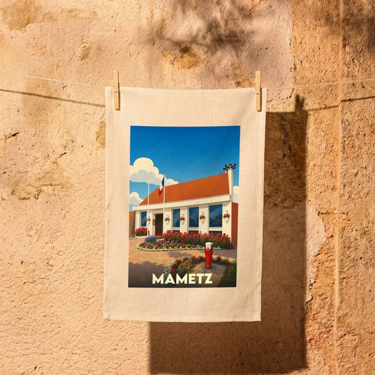 Torchon souvenir de la ville de Mametz avec une illustration stylisée d'un bâtiment fleuri.