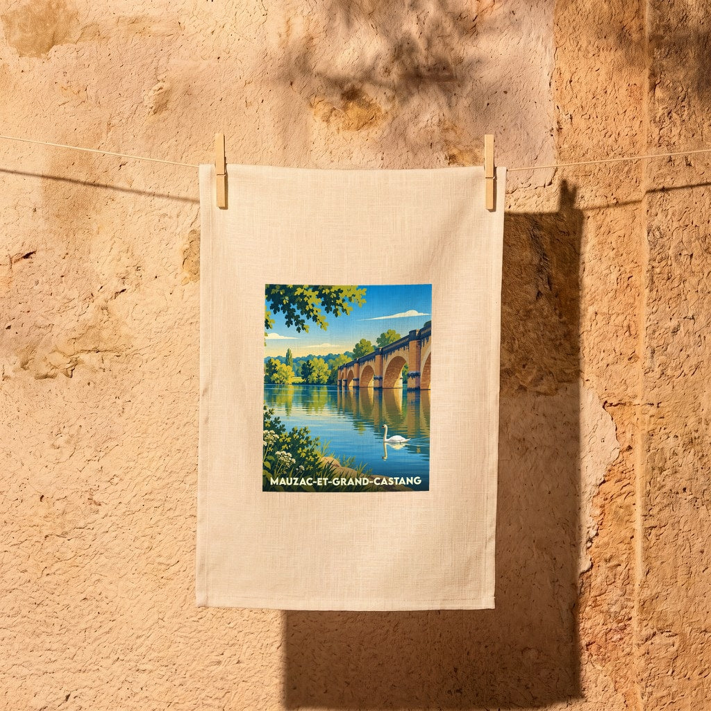 Torchon souvenir de la ville de Mauzac-et-Grand-Castang avec une illustration stylisée d'un pont et d'un cygne sur la rivière.