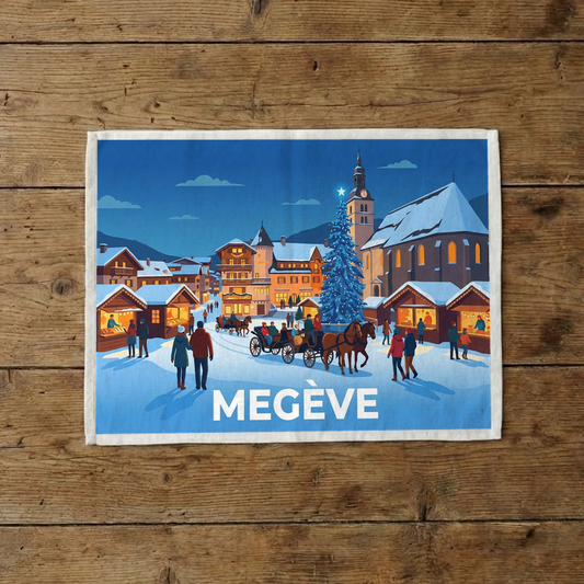 Torchon souvenir de la ville de Megève avec une illustration stylisée d'un paysage hivernal enneigé.