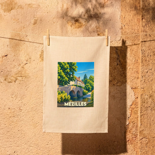 Torchon souvenir de la ville de Mézilles avec une illustration stylisée d'un pont en pierre.