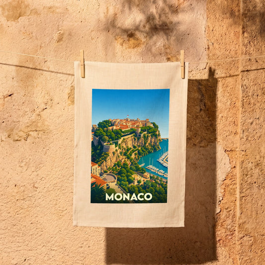 Torchon souvenir de la ville de Monaco orné d'une illustration stylisée de son rocher et de son port.