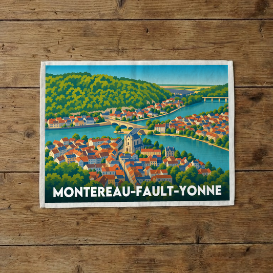 Torchon souvenir de la ville de Montereau-Fault-Yonne illustré par un paysage coloré de la ville au bord de l'eau.