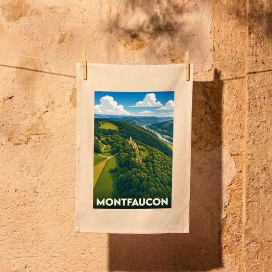 Torchon souvenir de la ville de Montfaucon avec une illustration de paysage vallonné.