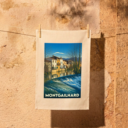 Torchon souvenir de la ville de Montgailhard avec une illustration stylisée d'un cours d'eau et de maisons.