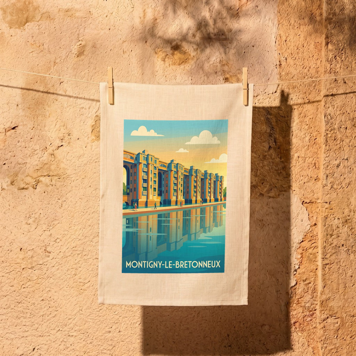 Torchon souvenir de la ville de Montigny-le-Bretonneux avec une illustration stylisée.