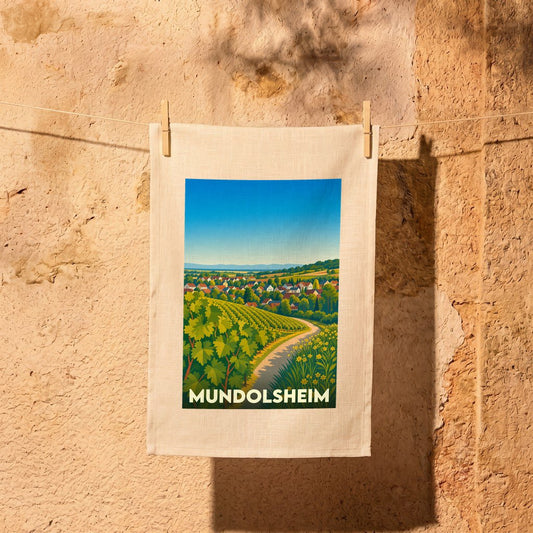 Torchon souvenir de la ville de Mundolsheim avec une illustration stylisée de vignobles et du village.