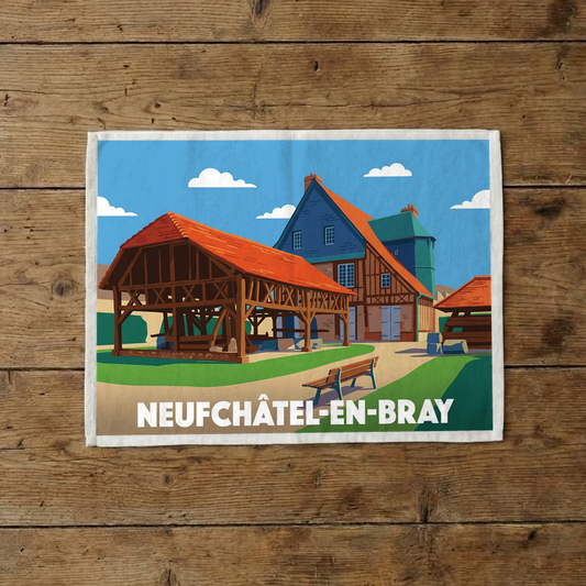 Torchon souvenir de la ville de Neufchâtel-en-Bray avec une illustration stylisée de bâtiments à colombages.