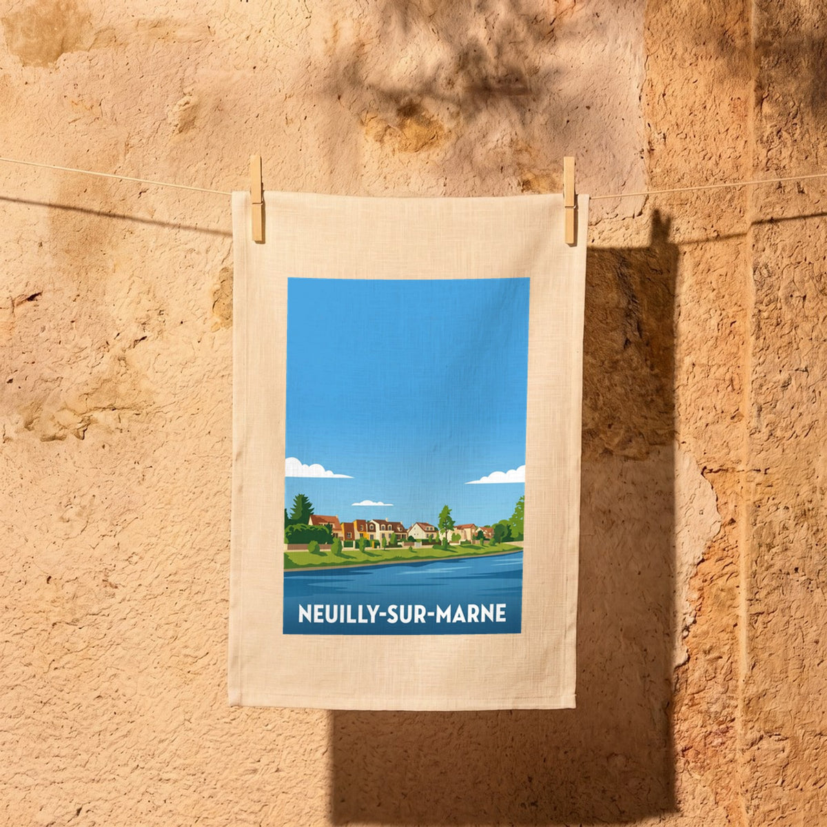 Torchon souvenir de la ville de Neuilly-sur-Marne avec une illustration stylisée des bords de la Marne.
