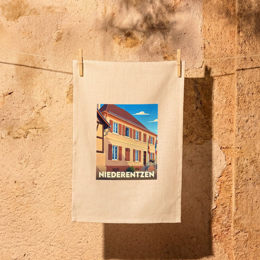 Torchon souvenir de la ville de Niederentzen avec une illustration stylisée d'un bâtiment traditionnel.