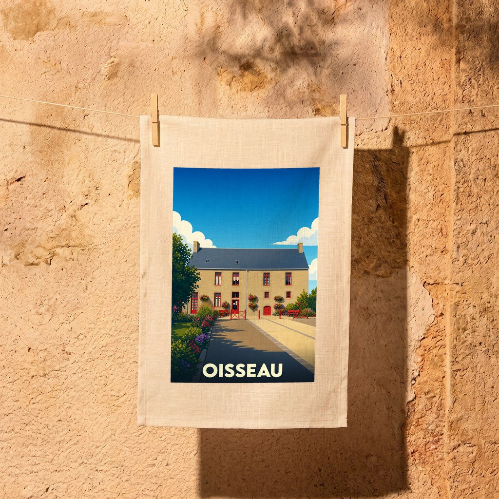 Torchon souvenir de la ville de Oisseau illustrant une bâtisse traditionnelle sous un ciel bleu.