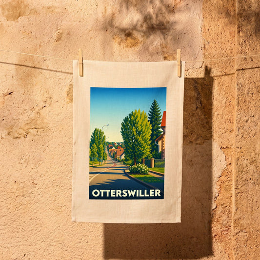 Torchon souvenir de la ville d'Otterswiller avec une illustration stylisée d'une rue arborée.