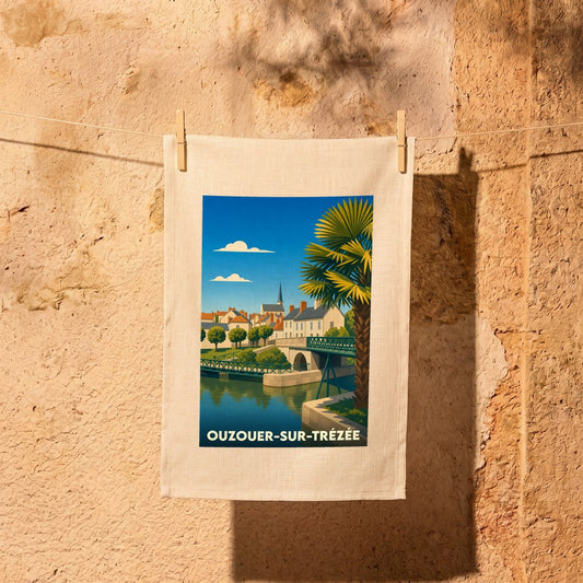 Torchon souvenir de la ville de Ouzouer-sur-Trézée avec une illustration stylisée de son pont et de son église.