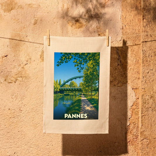 Torchon souvenir de la ville de Pannes avec une illustration stylisée d'un pont au-dessus d'un canal.