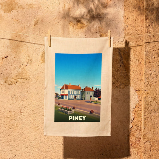 Torchon souvenir de la ville de Piney avec une illustration stylisée de ses bâtiments et du paysage urbain.