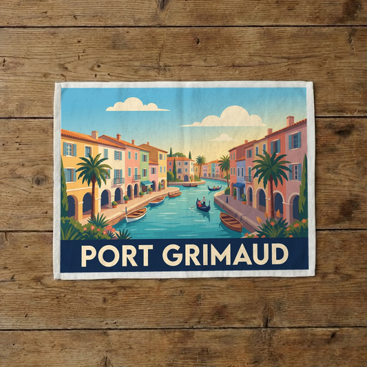 Torchon souvenir de la ville de Port Grimaud avec une illustration stylisée de ses canaux et maisons colorées.