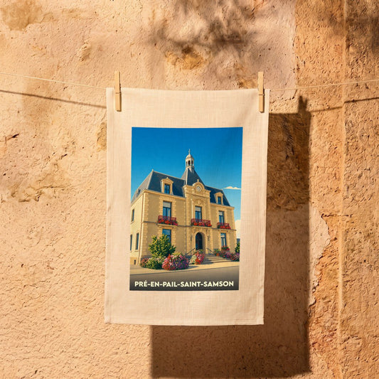 Torchon souvenir de la ville de Pré-en-Pail-Saint-Samson illustré de la mairie stylisée sous un ciel bleu.