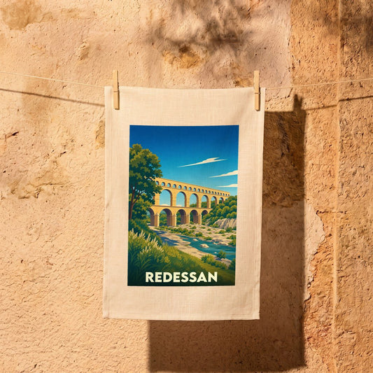 Torchon souvenir de la ville de Redessan avec une illustration stylisée du Pont du Gard.