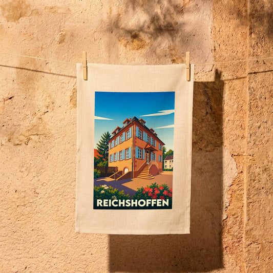 Torchon souvenir de la ville de Reichshoffen avec une illustration stylisée d'une maison alsacienne.
