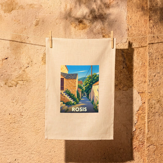 Torchon souvenir de la ville de Rosis avec une illustration stylisée d'une ruelle ensoleillée.