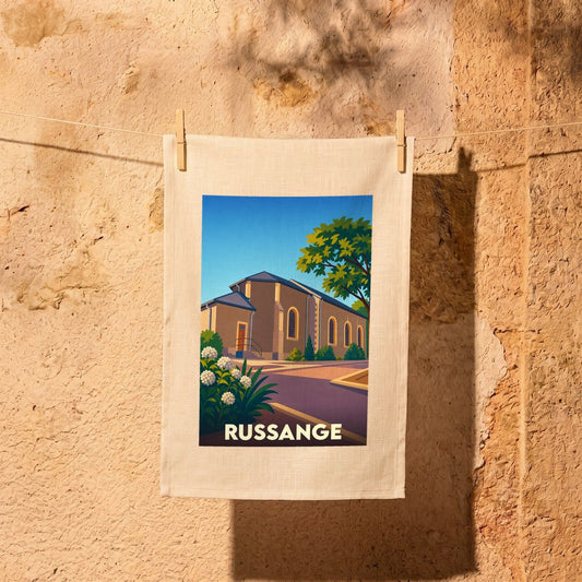 Torchon souvenir de la ville de Russange avec une illustration stylisée d'un bâtiment historique.