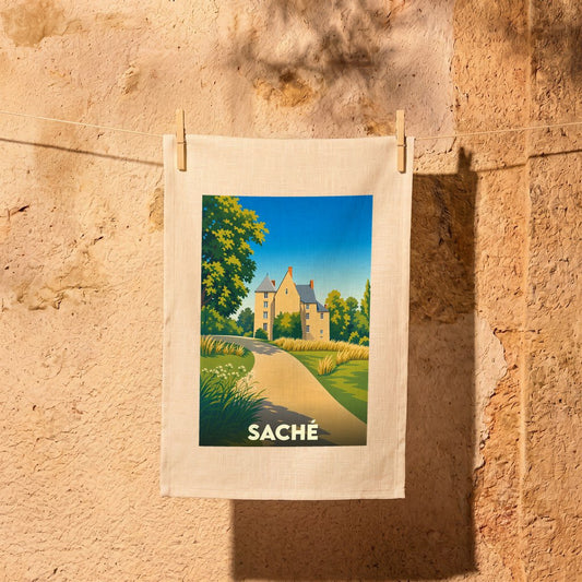Torchon souvenir de la ville de Saché avec une illustration stylisée d'un château et de son parc.