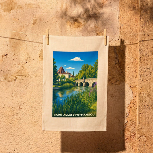 Torchon souvenir de Saint-Aulaye-Puymangou illustré d'un paysage stylisé avec rivière et château.