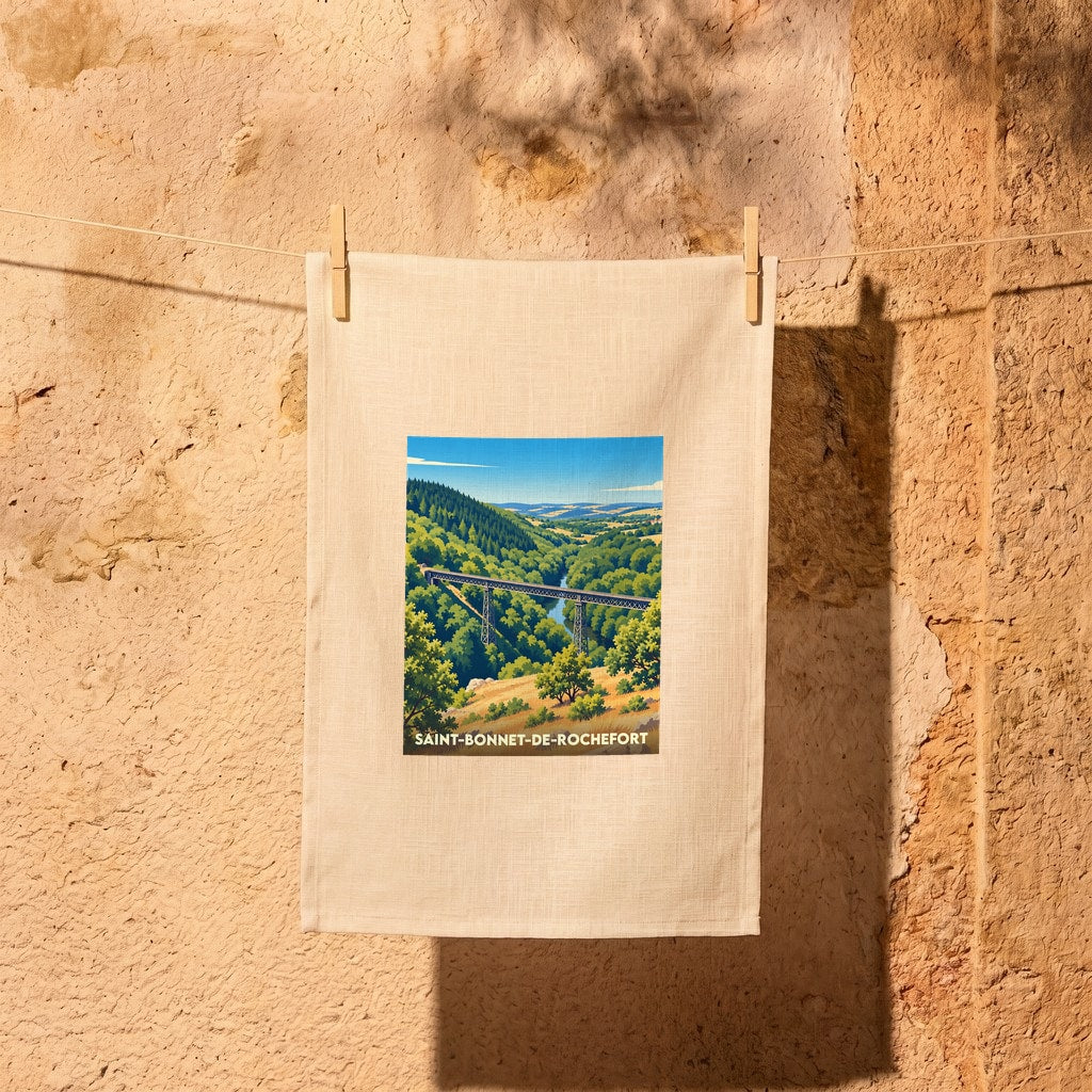 Torchon souvenir de la ville de Saint-Bonnet-de-Rochefort avec une illustration stylisée d'un viaduc dans un paysage verdoyant.