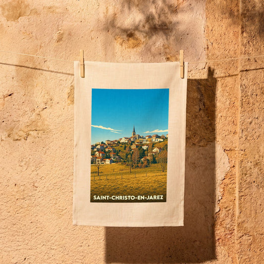 Torchon souvenir de la ville de Saint-Christo-en-Jarez avec une illustration stylisée.