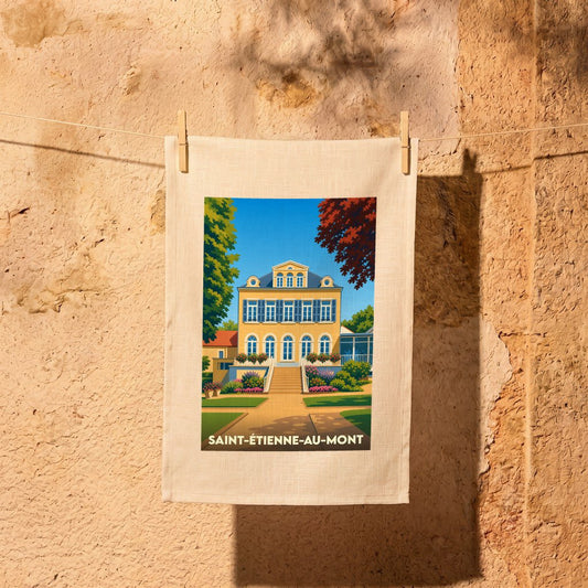 Torchon souvenir de la ville de Saint-Étienne-au-Mont avec une illustration stylisée d'une grande demeure jaune.