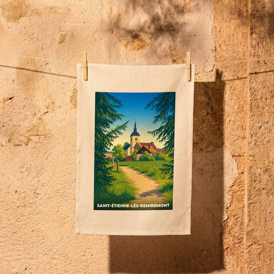 Torchon souvenir de Saint-Étienne-lès-Remiremont avec une illustration stylisée d'un paysage de campagne et son église.